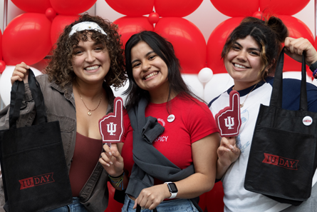 A group of three students celebrating IU Day.